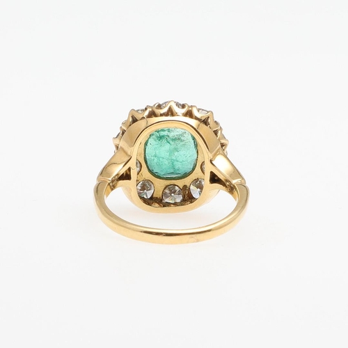 1294 - AN EMERALD AND DIAMOND CLUSTER RING. the oval-shaped emerald is set within a surround of circular-cu... 