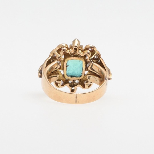 1295 - A COLUMBIAN EMERALD AND DIAMOND CLUSTER RING. the rectangular-shaped emerald is set within a surroun... 