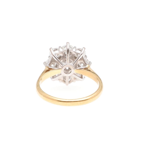 1297 - A DIAMOND CLUSTER RING. the central brilliant-cut diamond is set within a surround of eight smaller ... 