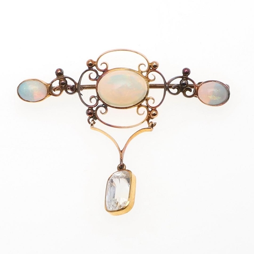 900 - AN OPAL AND GOLD BROOCH. the gold openwork mount is set with three oval solid white opals, suspendin... 