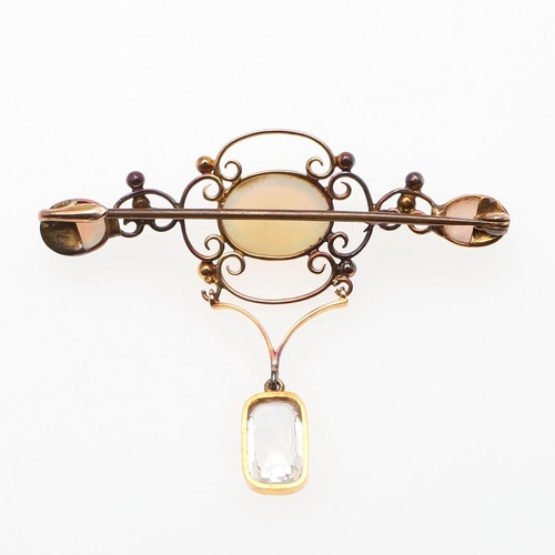 900 - AN OPAL AND GOLD BROOCH. the gold openwork mount is set with three oval solid white opals, suspendin... 