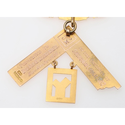 912 - A 9CT GOLD MASONIC MEDAL. mounted on a pale green ribbon, 25 grams, together with two other items.  ... 