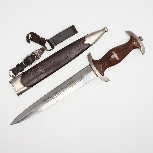 116 - A SECOND WORLD WAR GERMAN SA DAGGER AND SCABBARD. With a 22cm pointed, double edged blade inscribed ... 