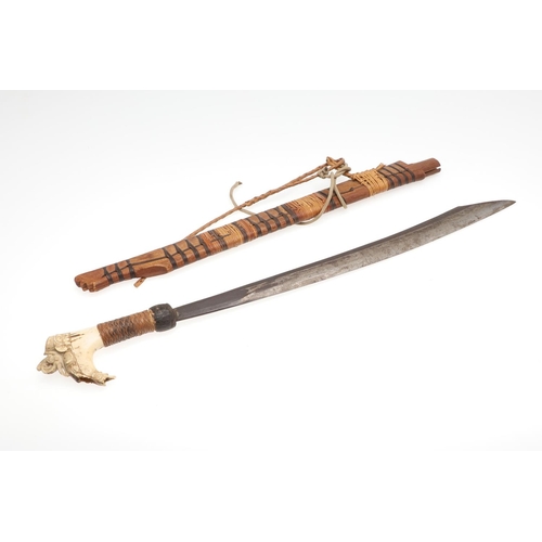 127 - A BORNEO DYACK SWORD AND SCABBARD AND A SIMILAR KNIFE AND SHEATH. A Dyack 'Headhunters' sword with a... 