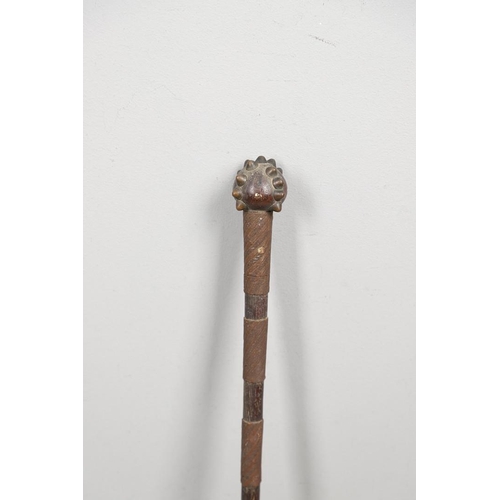 148 - AN AFRICAN TRIBAL CLUB WITH STUDDED HEAD. A tribal club with a round head with a cross pattern of se... 