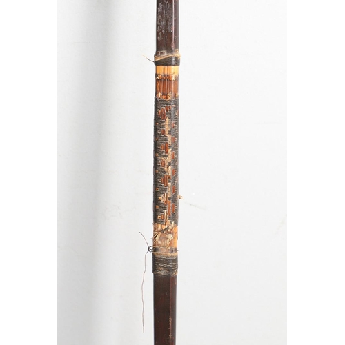 149 - AN AFRICAN LONG BOW. A flat fronted long bow with raffia wound grip, probably African late 19th or e... 