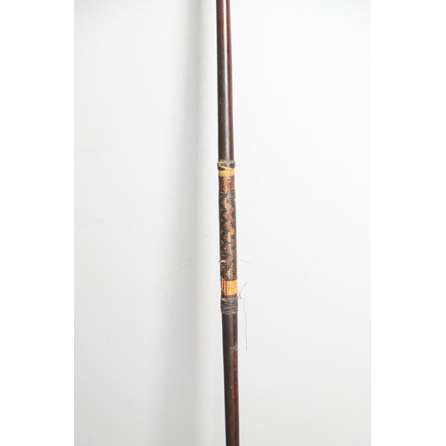 149 - AN AFRICAN LONG BOW. A flat fronted long bow with raffia wound grip, probably African late 19th or e... 