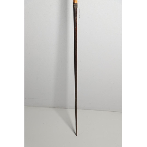 149 - AN AFRICAN LONG BOW. A flat fronted long bow with raffia wound grip, probably African late 19th or e... 