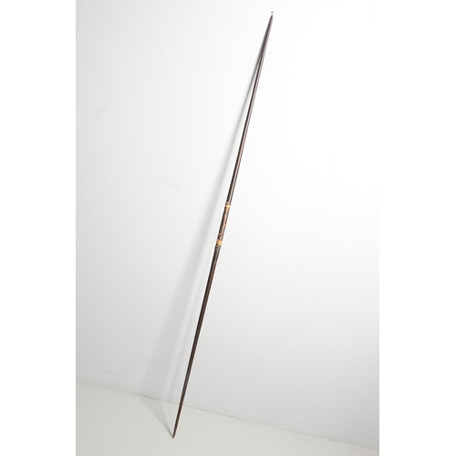 149 - AN AFRICAN LONG BOW. A flat fronted long bow with raffia wound grip, probably African late 19th or e... 