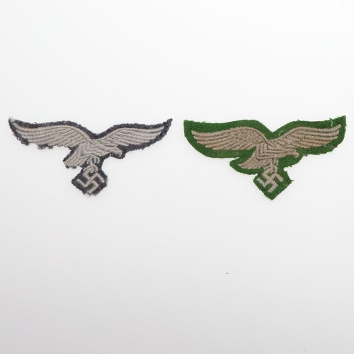 166 - TWO LUFTWAFFE OTHER RANKS FABRIC BREAST EAGLES. Two fabric patches, one pale grey with machine-woven... 