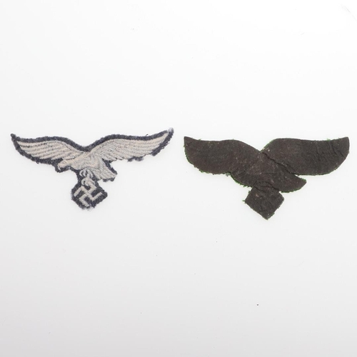 166 - TWO LUFTWAFFE OTHER RANKS FABRIC BREAST EAGLES. Two fabric patches, one pale grey with machine-woven... 