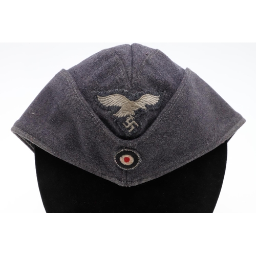 183 - A SECOND WORLD WAR GERMAN LUFTWAFFE OTHER RANKS FORAGE CAP. A folding forage cap in Luftwaffe blue m... 