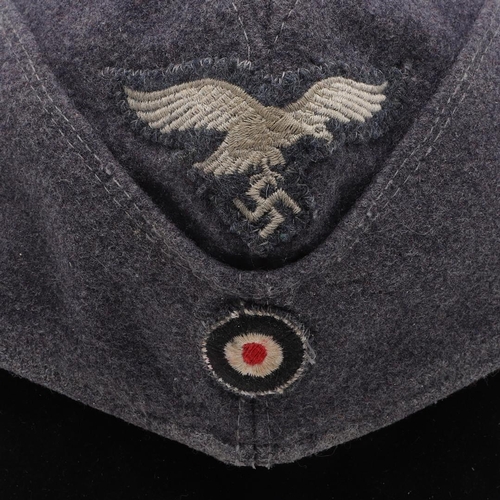 183 - A SECOND WORLD WAR GERMAN LUFTWAFFE OTHER RANKS FORAGE CAP. A folding forage cap in Luftwaffe blue m... 