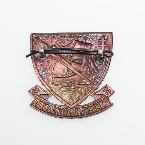 201 - A FRENCH COMMANDO CAP BADGE. A cap badge of shield shape with a sailing ship in full sail with comma... 