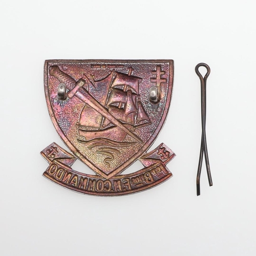 201 - A FRENCH COMMANDO CAP BADGE. A cap badge of shield shape with a sailing ship in full sail with comma... 