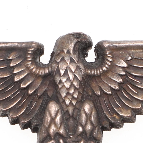 216 - A WAFFEN-SS OFFICER'S PEAKED CAP EAGLE. An early war type Waffen-SS Officer's Peaked Cap Eagle, silv... 