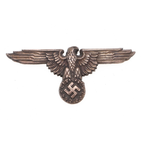 216 - A WAFFEN-SS OFFICER'S PEAKED CAP EAGLE. An early war type Waffen-SS Officer's Peaked Cap Eagle, silv... 