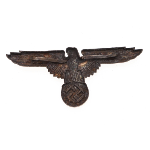 216 - A WAFFEN-SS OFFICER'S PEAKED CAP EAGLE. An early war type Waffen-SS Officer's Peaked Cap Eagle, silv... 