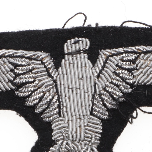 217 - A WAFFEN-SS OFFICER'S ARM EAGLE. A Waffen-SS Officer's Arm eagle in silver bullion wire on a black f... 