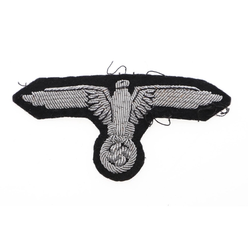 217 - A WAFFEN-SS OFFICER'S ARM EAGLE. A Waffen-SS Officer's Arm eagle in silver bullion wire on a black f... 