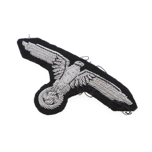 217 - A WAFFEN-SS OFFICER'S ARM EAGLE. A Waffen-SS Officer's Arm eagle in silver bullion wire on a black f... 