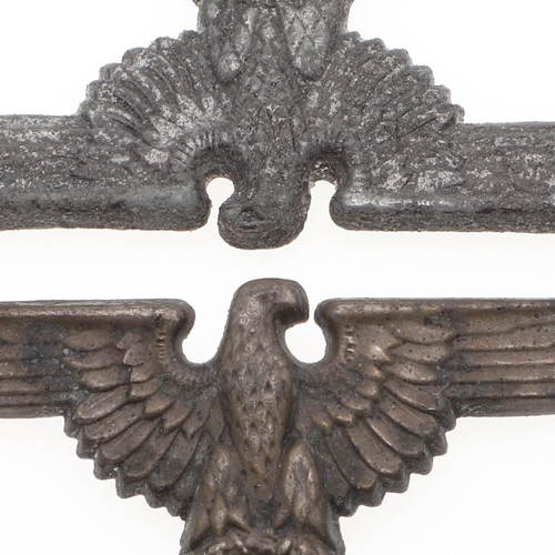 218 - TWO WAFFEN SS PEAKED CAP EAGLES. Two late war type peaked cap eagles in zinc with brass pins, hollow... 