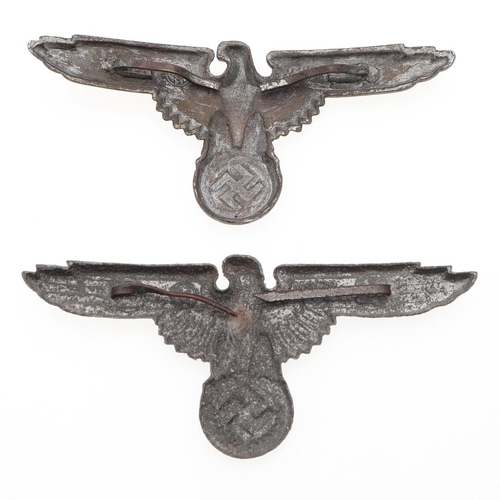 218 - TWO WAFFEN SS PEAKED CAP EAGLES. Two late war type peaked cap eagles in zinc with brass pins, hollow... 