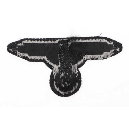 225 - A WAFFEN-SS MAN'S BEVO TYPE ARM-EAGLE. A Man's Bevo type arm-eagle machine woven in grey silk type t... 