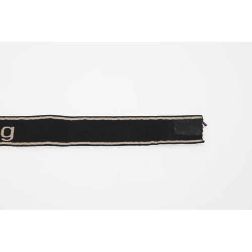 237 - A SECOND WORLD WAR GERMAN 'WIKING' CUFF TITLE. A machine embroidered cuff title 'Wiking' in white ag... 