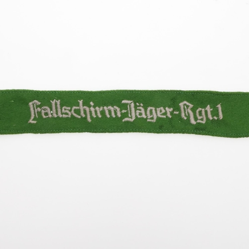 241 - A SECOND WORLD WAR GERMAN 'FALLSCHIRM JAGER RGT 1' CUFF TITLE. A machine embroidered cuff title 'Fal... 