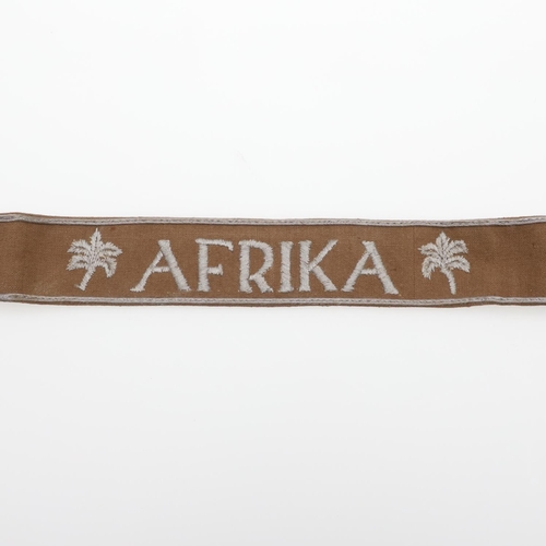 242 - A SECOND WORLD WAR GERMAN 'AFRIKA' CUFF TITLE. A machine embroidered cuff title for the Afrika Corps... 