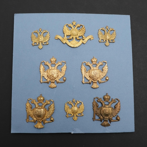 247 - AN INTERESTING COLLECTION OF EIGHT 1ST KING'S DRAGOON GUARDS CAP AND COLLAR BADGES. A collection of ... 