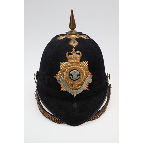 261 - A ROYAL REGIMENT OF WALES 1878 PATTERN HELMET. A British Home Service 1878 pattern cloth helmet with... 