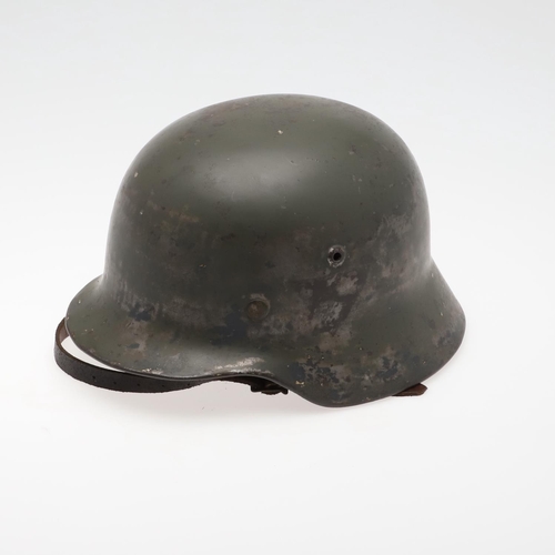 271 - A BLACK M40 TYPE HELMET AND LINER. A Second World War or later finished M40 type steel helmet shell,... 