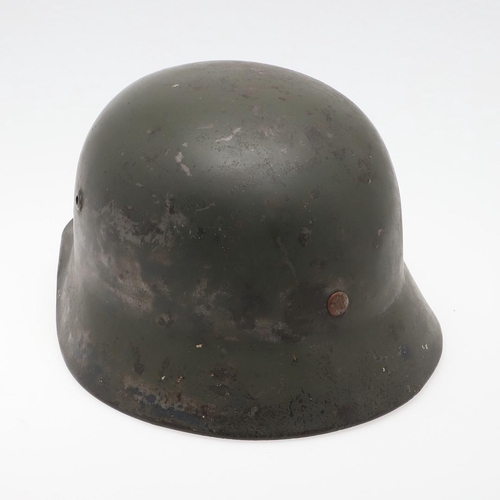 271 - A BLACK M40 TYPE HELMET AND LINER. A Second World War or later finished M40 type steel helmet shell,... 