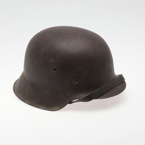 272 - A BLACK M42 TYPE HELMET AND LINER. A Second World War or later finished M42 type steel helmet shell,... 