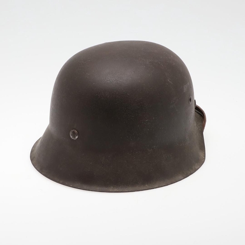 272 - A BLACK M42 TYPE HELMET AND LINER. A Second World War or later finished M42 type steel helmet shell,... 