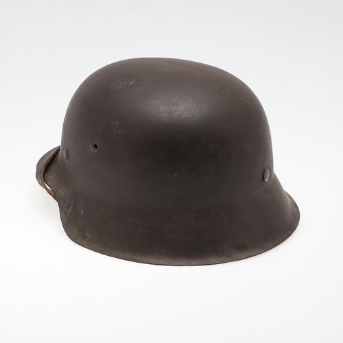 272 - A BLACK M42 TYPE HELMET AND LINER. A Second World War or later finished M42 type steel helmet shell,... 