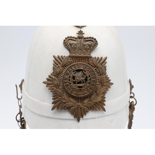 274 - A WHITE FOREIGN SERVICE HELMET WITH SOUTH WALES BORDERERS HELMET PLATE. With a brass hexagonal spike... 