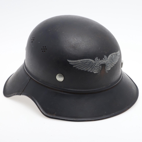 276 - A GERMAN LUFTSCHUTZ GLADIATOR PATTERN HOME DEFENCE HELMET. A Steel helmet with four seven hole air v... 