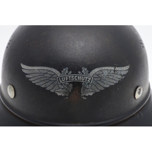 276 - A GERMAN LUFTSCHUTZ GLADIATOR PATTERN HOME DEFENCE HELMET. A Steel helmet with four seven hole air v... 