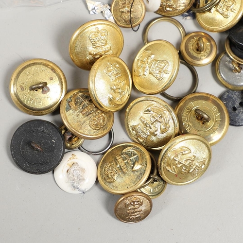 299 - A COLLECTION OF ROYAL NAVY BUTTONS AND INSIGNIA AND A LARGE SHELL CASING. A large polished brass she... 