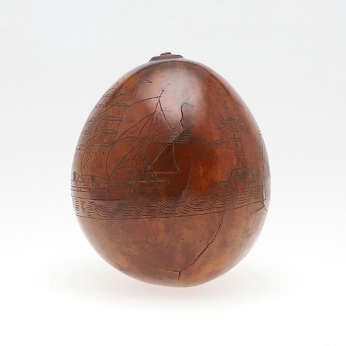 311 - AN UNUSUAL AMERICAN HAWAIIAN NAUTICAL CARVED TROPICAL NUT. An incised tropical nut with a three mast... 