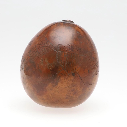 311 - AN UNUSUAL AMERICAN HAWAIIAN NAUTICAL CARVED TROPICAL NUT. An incised tropical nut with a three mast... 