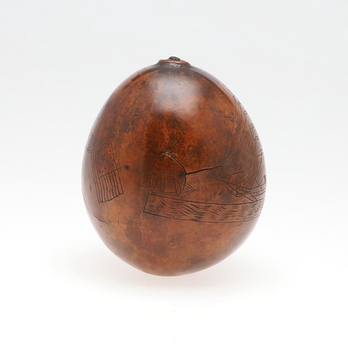 311 - AN UNUSUAL AMERICAN HAWAIIAN NAUTICAL CARVED TROPICAL NUT. An incised tropical nut with a three mast... 