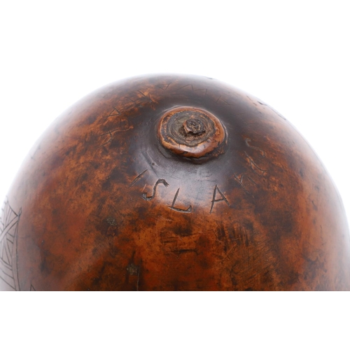 311 - AN UNUSUAL AMERICAN HAWAIIAN NAUTICAL CARVED TROPICAL NUT. An incised tropical nut with a three mast... 