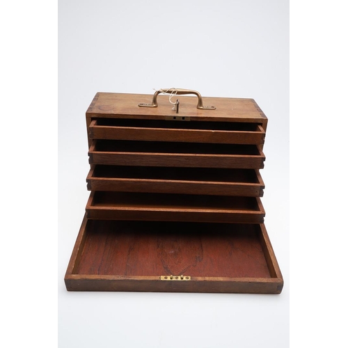 316 - A PORTABLE COLLECTORS CABINET. A wooden collectors cabinet with a brass carrying handle, the fall-fr... 