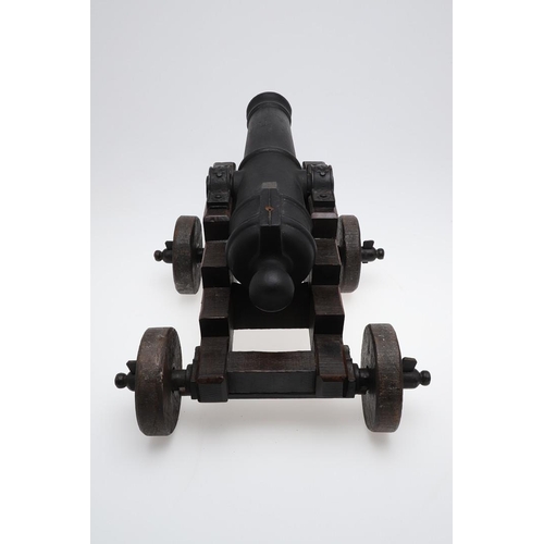 34 - A CAST IRON SIGNAL CANNON ON WOODEN CARRIAGE. A signal cannon with a 48cm iron barrel inset with a r... 