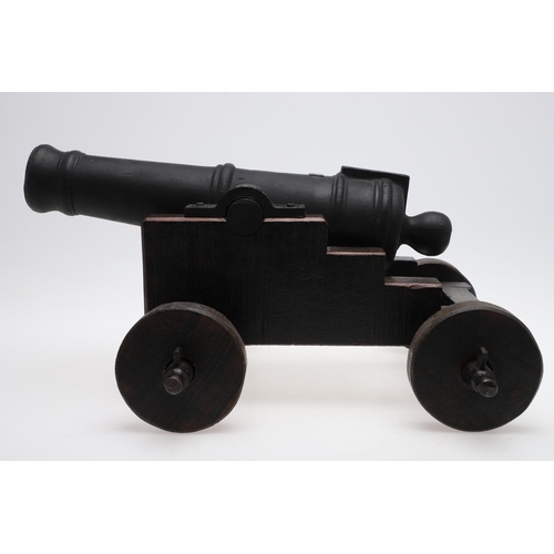 34 - A CAST IRON SIGNAL CANNON ON WOODEN CARRIAGE. A signal cannon with a 48cm iron barrel inset with a r... 