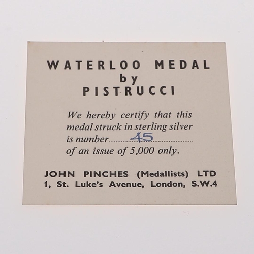 355 - PISTRUCCI WATERLOO MEDAL BY JOHN PINCHES. A silver medal commemorating the Battle of Waterloo, a red... 